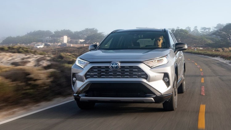 silver toyota rav4 hybrid driving
