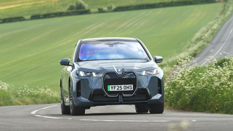 2025 BMW iX RHD grey exterior front view driving