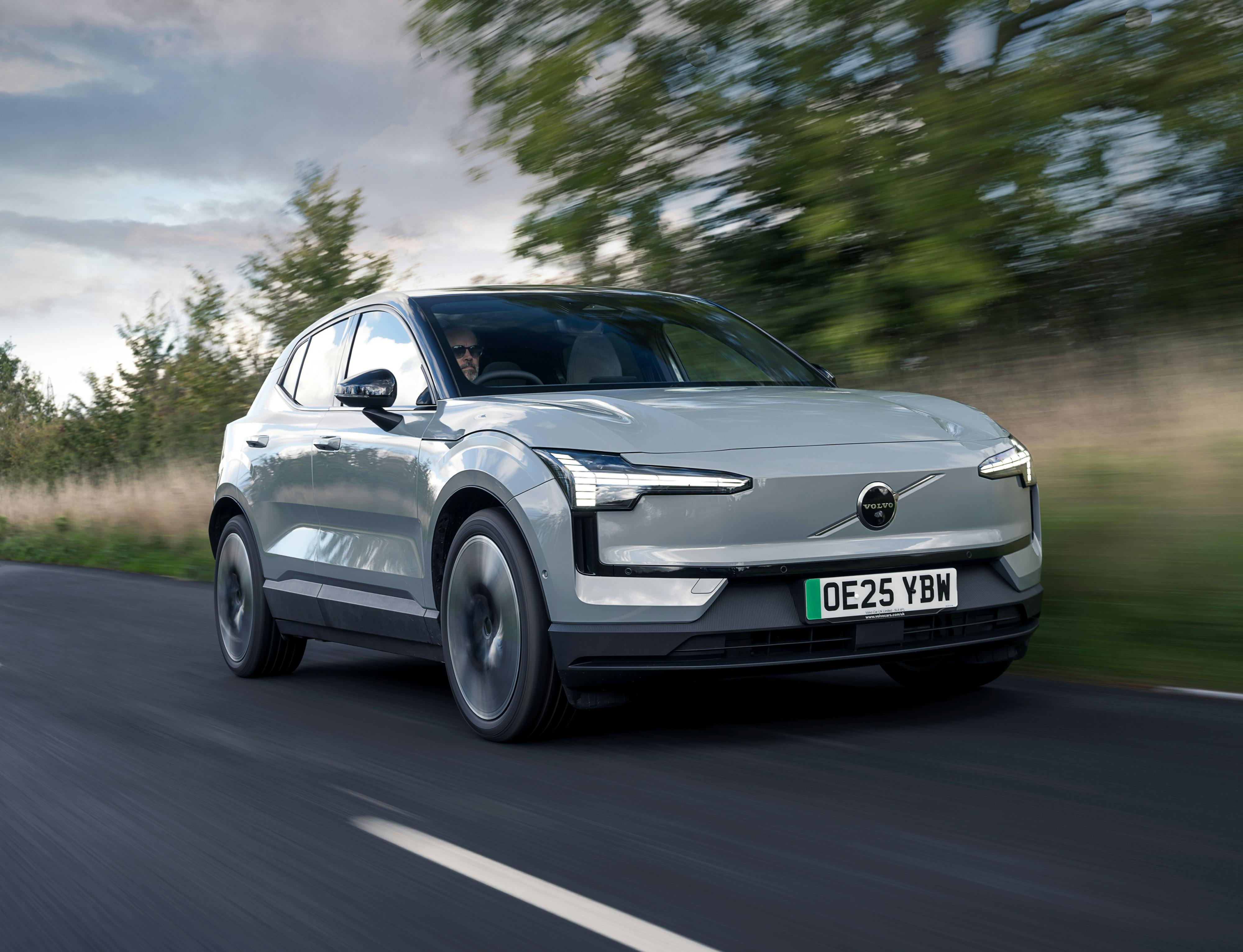 A 2025 Volvo EX30 driving on a country road